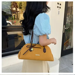 Model carrying a vintage mustard yellow Boston handbag for a stylish commuter look