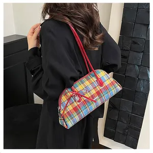 Vintage colorful plaid shoulder bag featuring a red bow and a silver heart charm detail