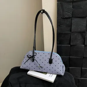 Vintage blue striped shoulder bag with black heart patterns and elegant bow detail