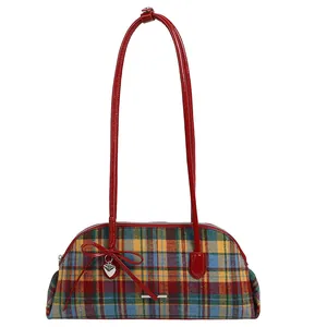 Retro plaid patterned underarm shoulder bag with vibrant red handles and cute heart charm detail