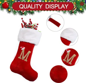 Detailed view of large red Christmas stocking with gold embroidered letter M for quality display