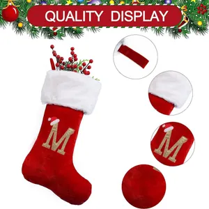 Large red Christmas stocking with embroidered golden letter M and white plush trim