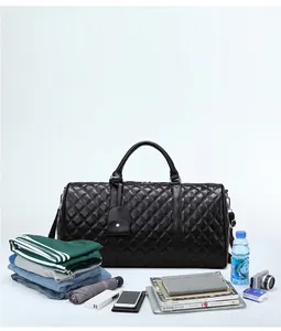 Black quilted duffle bag shown with various travel essentials like clothes and books.
