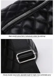 Close-up of silver zipper and adjustable buckle on black quilted travel bag