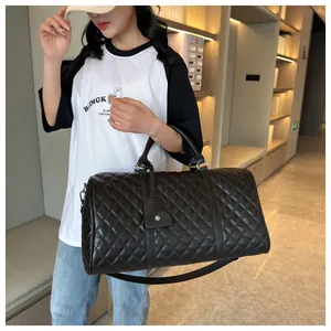 Black quilted leather duffle bag for travel with shoulder strap and trolley sleeve