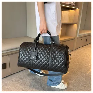 Stylish black quilted duffle bag shown in use, perfect for travel or gym sessions.