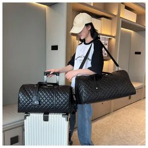 Large black quilted travel duffle bag for women, stylish carry-on luggage for trips