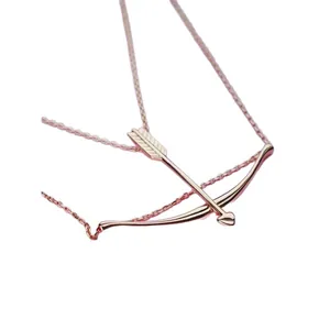 Elegant rose gold bow and arrow necklace featuring a heart-shaped arrowhead pendant