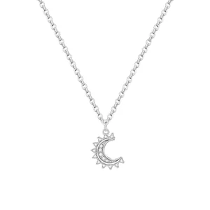 Close-up of a silver-tone crescent moon pendant necklace with delicate sparkling stones