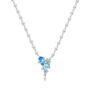 Elegant silver star and moon necklace featuring blue teardrop crystals and shiny gems
