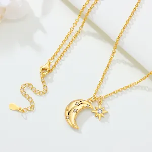 Close-up detail of a gold-plated moon and star necklace featuring cubic zirconia accents.