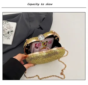 Internal capacity display of a golden heart-shaped evening clutch bag with chain