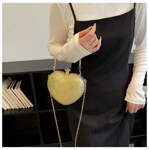Elegant gold heart-shaped evening clutch bag with metallic chain strap for parties