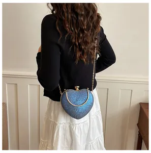 Detailed back view of a blue sequined heart-shaped evening bag with gold chain