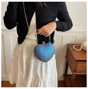 Elegant blue glitter heart-shaped evening clutch bag featuring a gold chain strap for women