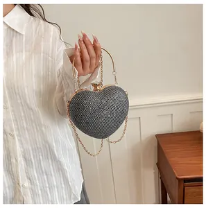 Close-up of heart-shaped evening bag with crystal mesh and gold chain.