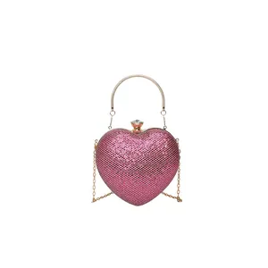 Elegant rose red heart-shaped evening clutch bag with sparkling gold chain and handle