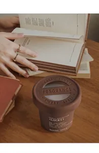 Close-up of brown ice cream sundae solid air freshener on a wooden desk with books