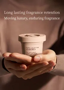 Detailed view of hands holding a beige ice cream cup-shaped flameless aromatherapy diffuser