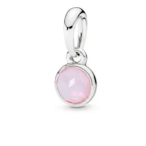 Close-up of pink faceted birthstone charm pendant in silver plated finish for bracelets.