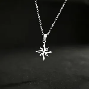 Minimalist titanium steel eight-pointed star necklace on dark textured background
