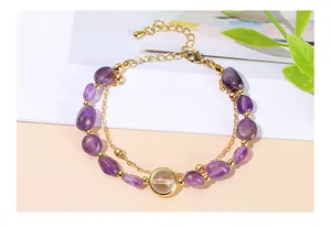 Close-up of natural amethyst beaded double-strand bracelet with citrine stone.