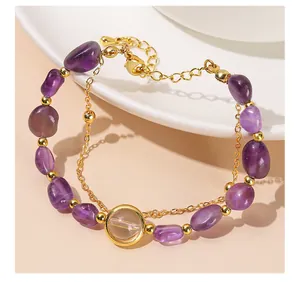 Close-up detail showing the natural purple amethyst irregular stones and gold beads.