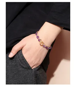 Detailed close-up of a double-layered natural purple amethyst bracelet on a wrist.
