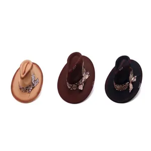 Detail of western fedora hats with snakeskin bands and feather accents in three colors.