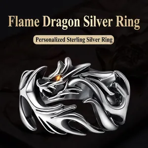 Macro detail of a silver-toned dragon ring featuring intricate scales and orange glow