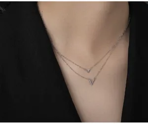Close-up of S925 silver double-layered necklace with triangle and V-shaped pendants