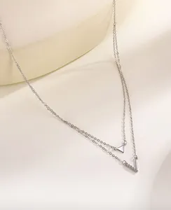 Detailed macro view of an S925 sterling silver double-layered V and triangle pendant necklace