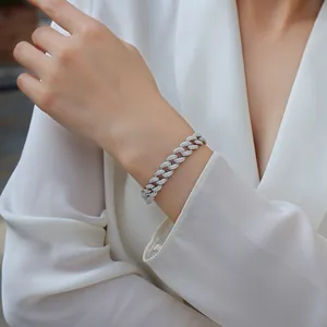 Close-up detail of a 10mm silver Moissanite Cuban link bracelet worn on a model's wrist