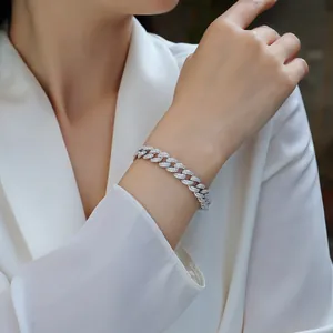Sparkling 10mm moissanite silver Cuban link bracelet worn with a white blazer for a luxury look