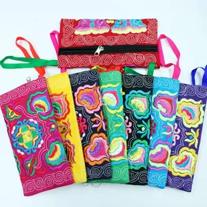 Vibrant embroidered ethnic style canvas pouches with intricate floral patterns and zip