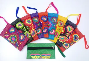 Detail of Yunnan ethnic style canvas embroidered pouches in various vibrant colors