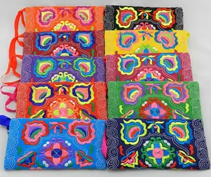 Detailed view of colorful ethnic style canvas clutches with vibrant floral embroidery patterns