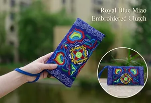 Close-up detail of ethnic style royal blue pouch featuring vibrant Miao flower embroidery