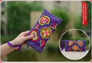 Detailed view of the intricate floral embroidery on the purple ethnic style canvas phone bag