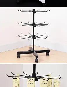 Detailed view of a multifunctional three-tier rotating black metal mobile display stand