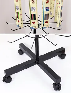 Detail view of black mobile rotating floor display rack showing hooks and wheels