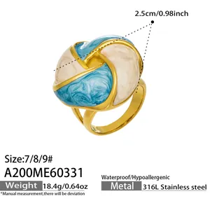 Detail shot of the stainless steel ring featuring blue and white enamel petal design