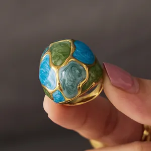 Exaggerated stainless steel ring with colorful blue and green enamel floral patterns