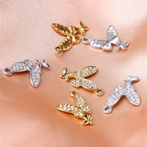 Detailed macro shot of alloy butterfly charms with sparkling rhinestones for DIY jewelry