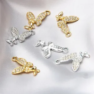 Close-up of alloy butterfly charms with sparkling rhinestones for DIY jewelry making.