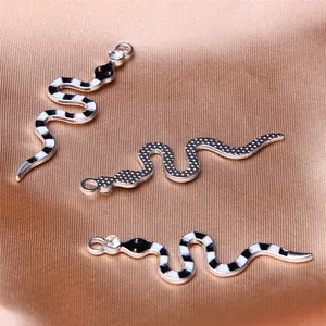 Detailed macro view of snake alloy charms for DIY jewelry making with enamel finish.