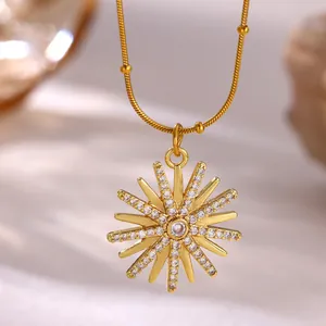 Close-up of 18K gold plated sunburst pendant necklace with micro pave stones.