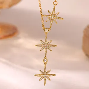 Macro detail of 18K gold plated copper necklace featuring triple starburst pendants