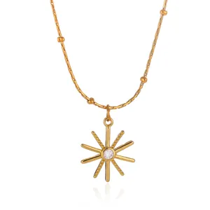 Detailed macro shot of 18K gold plated sunburst star pendant necklace with CZ stone