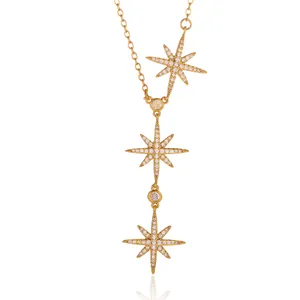 Detail of triple gold-plated starburst pendants with micro-pave zirconia crystals